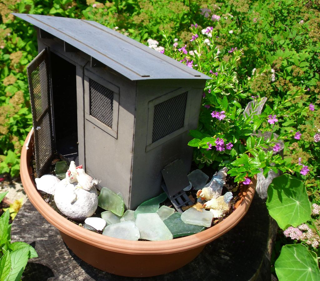 The tiny pink flowers of the fairy garden work well with the figurines.